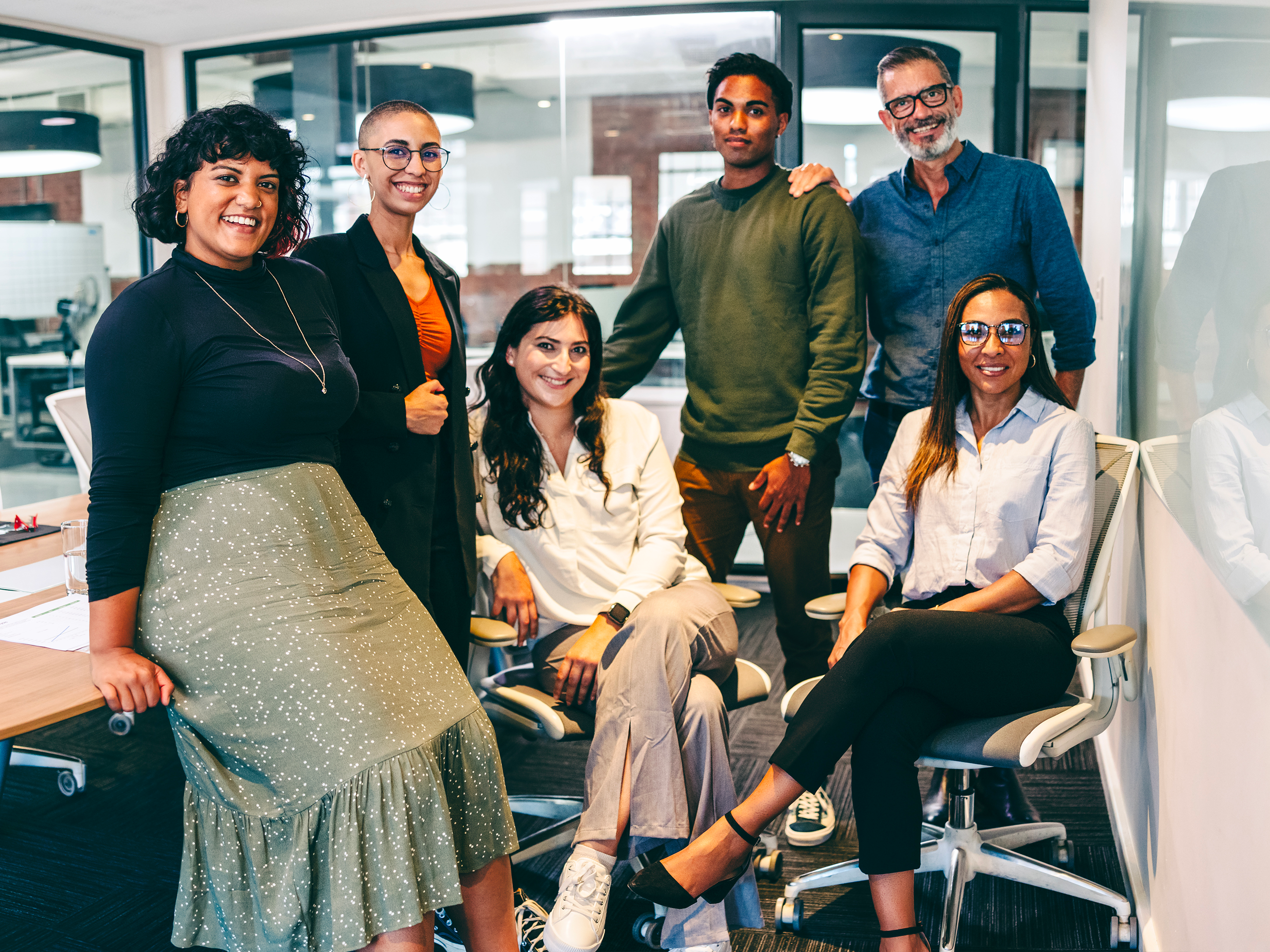 group of coworkers pose for a photo together at the office