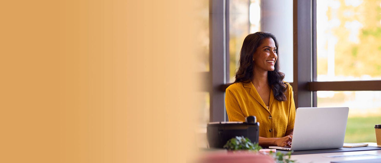 three people talking and smiling at work