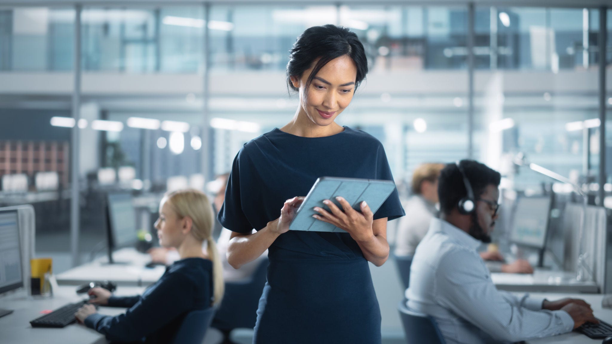 Woman uses her tablet to complete work