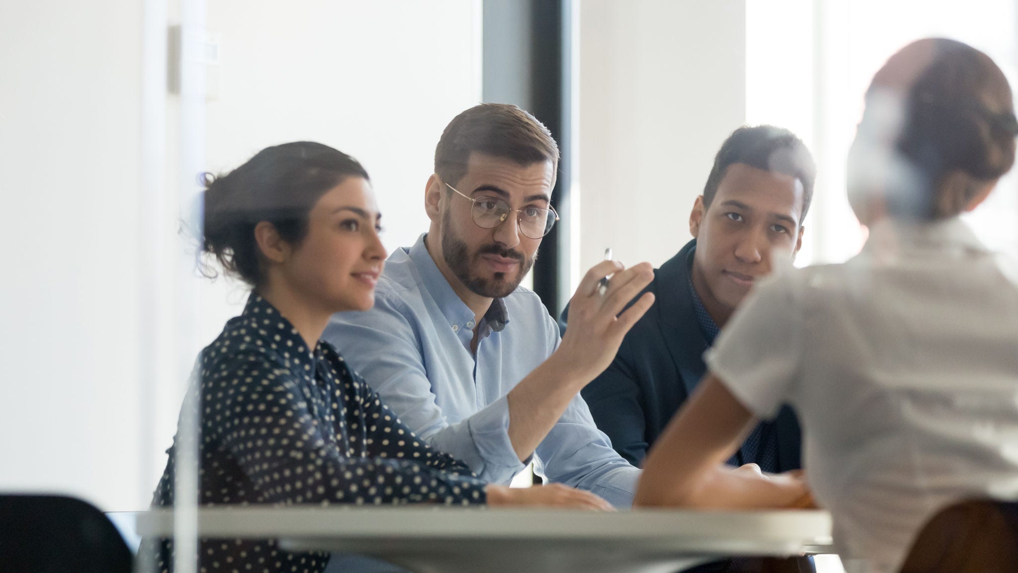 Colleagues have a discussion during a meeting.