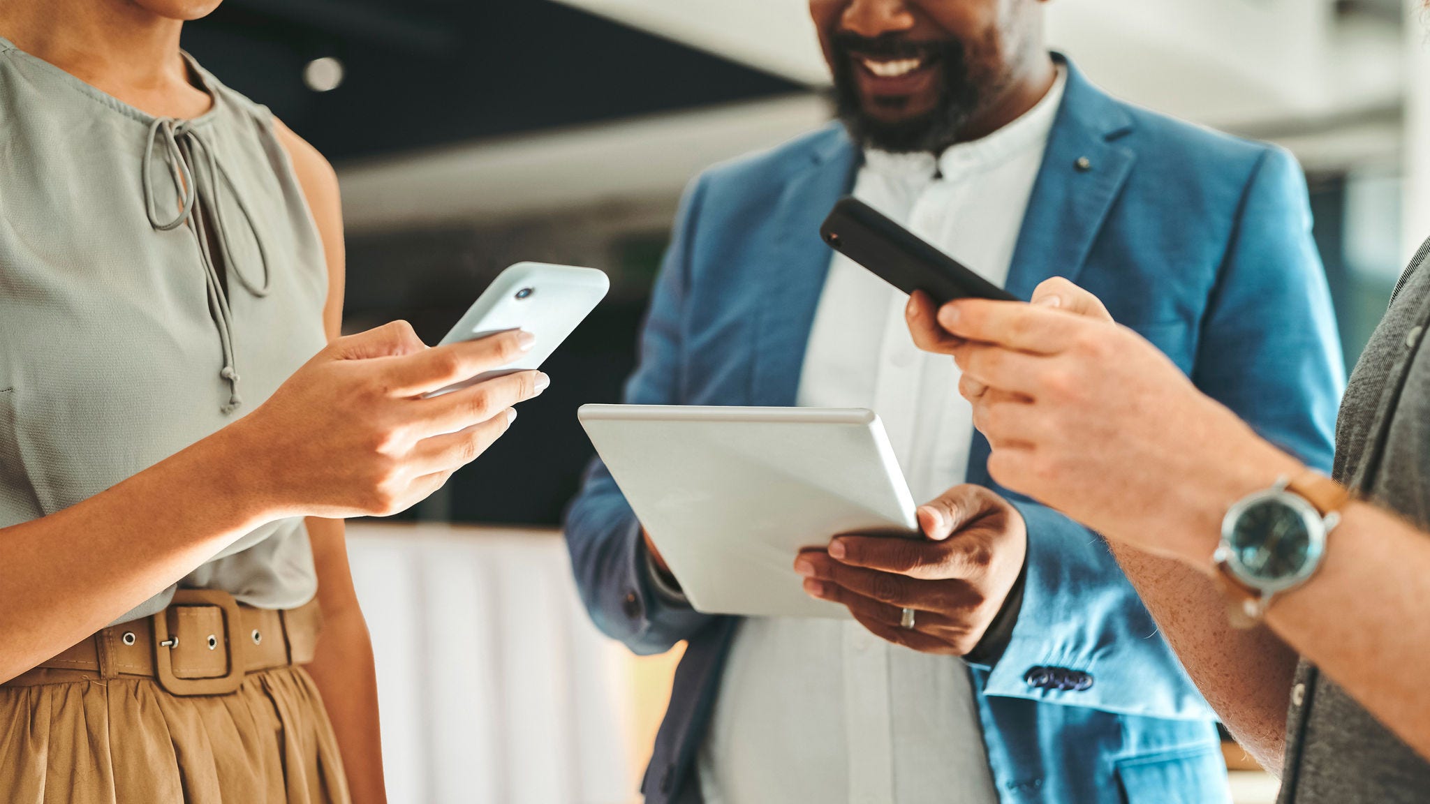 coworkers collaborate over phones and tablets