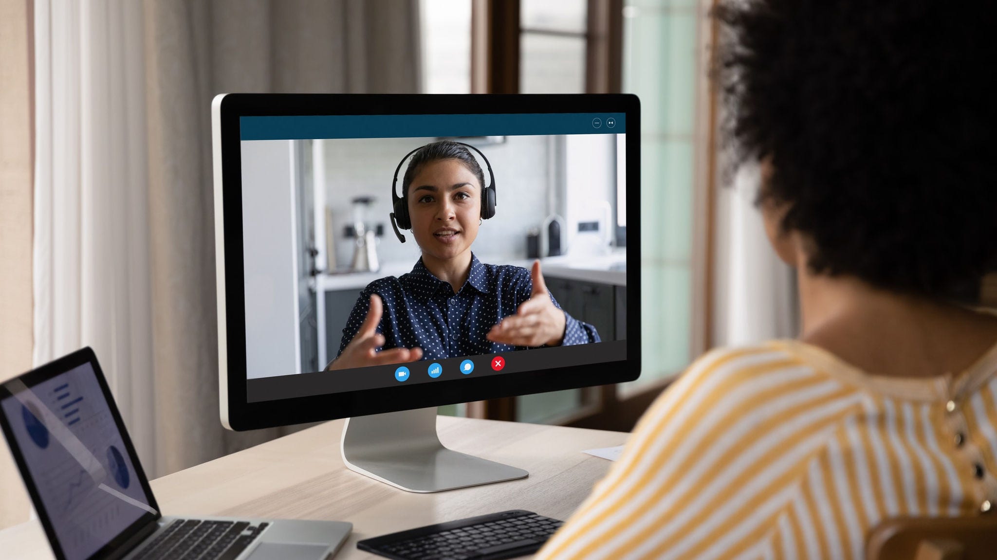 A woman is using a computer to make a video call.