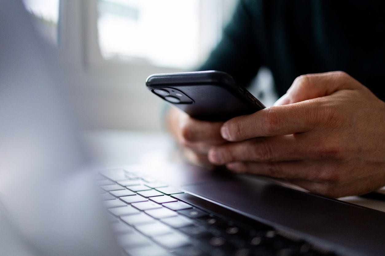 business person looking at smartphone