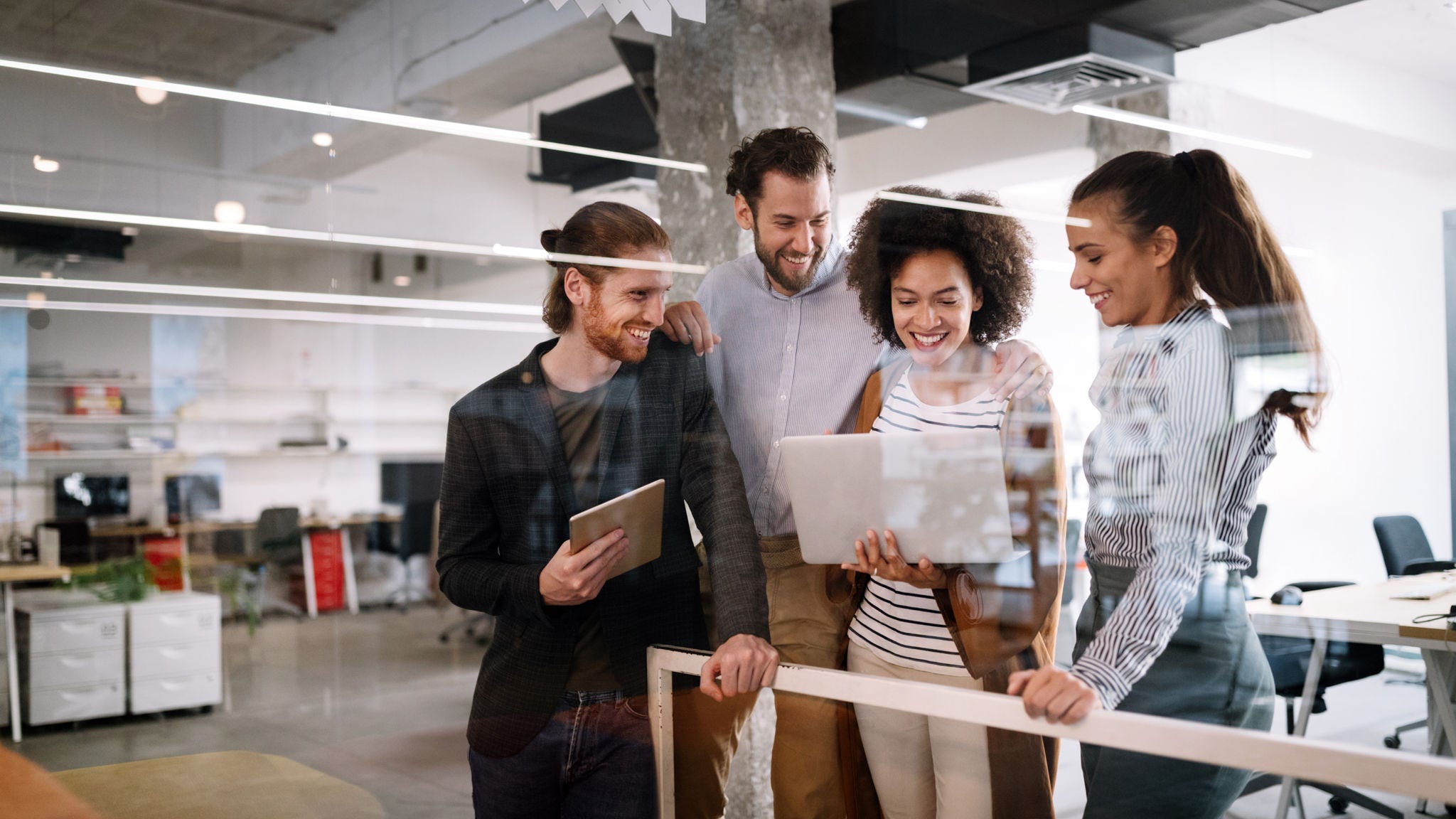 Coworkers all collaborate in a shared workspace.