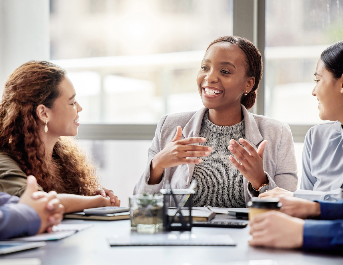 a diverse group of colleagues meet around a conference table