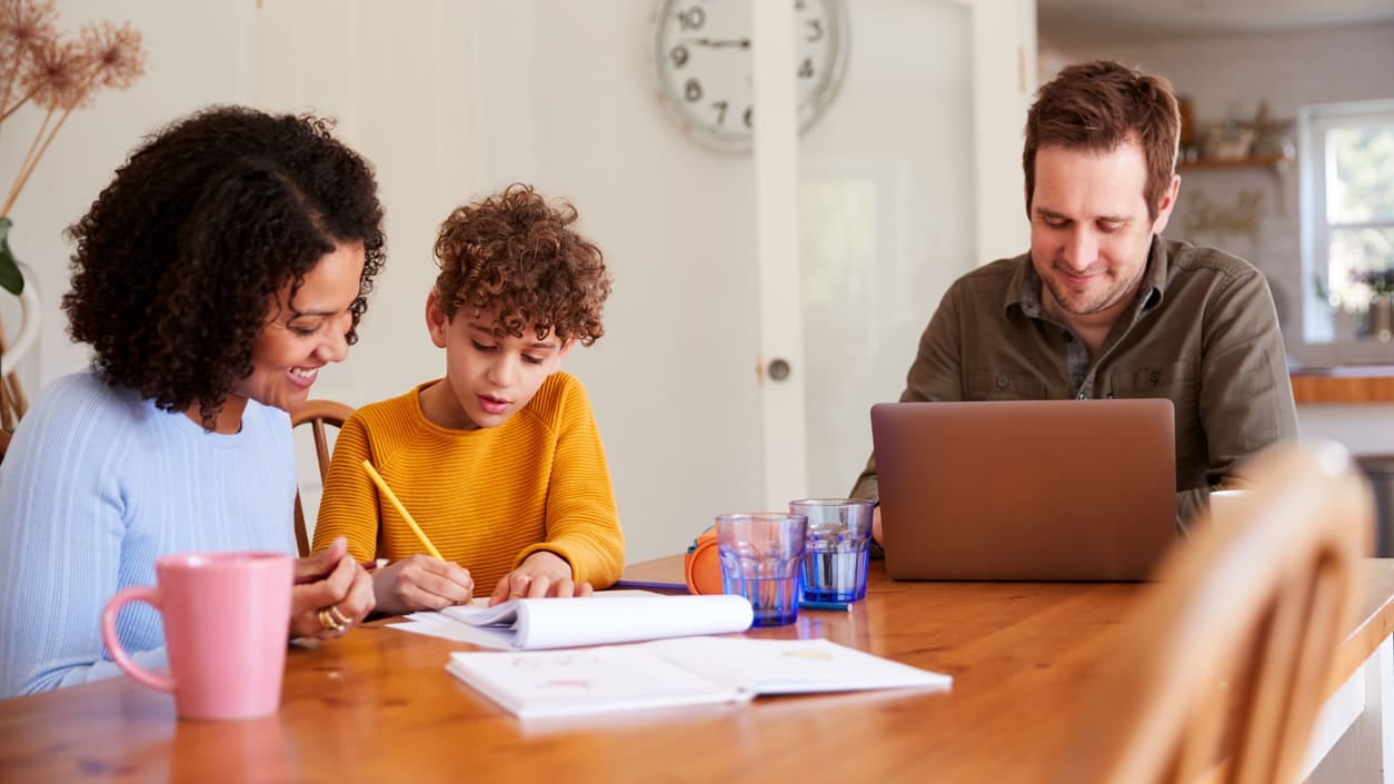 father working from home supporting wife and child