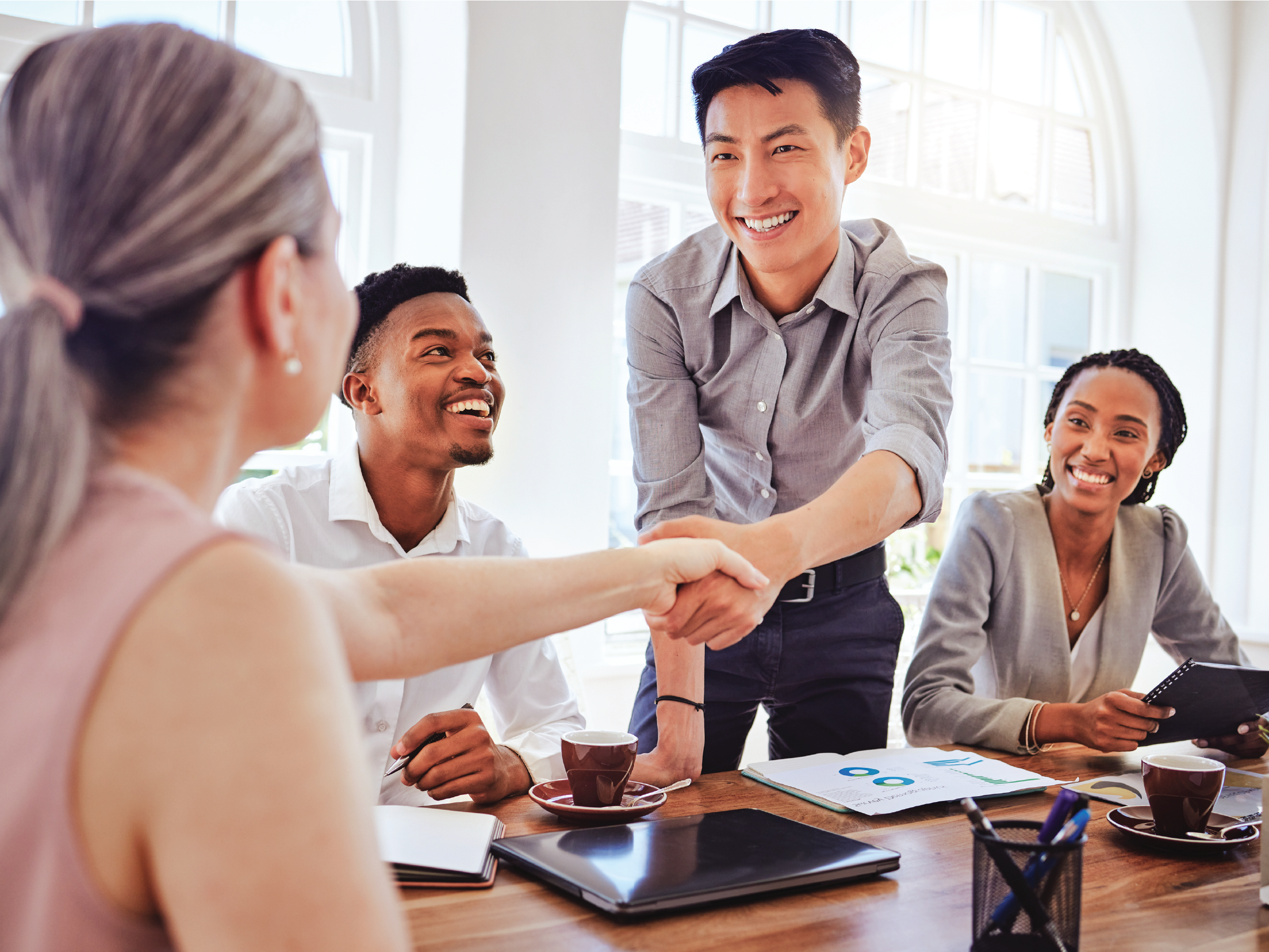 Colleague shakes hand with advisor.