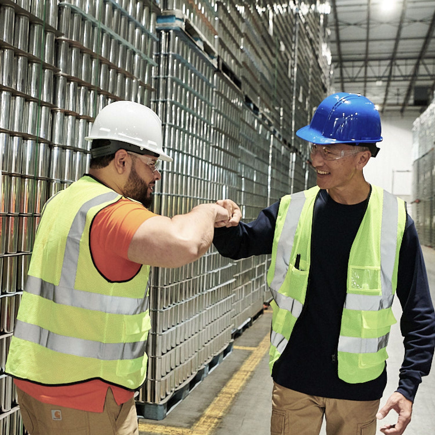 two construction workers fistbumping