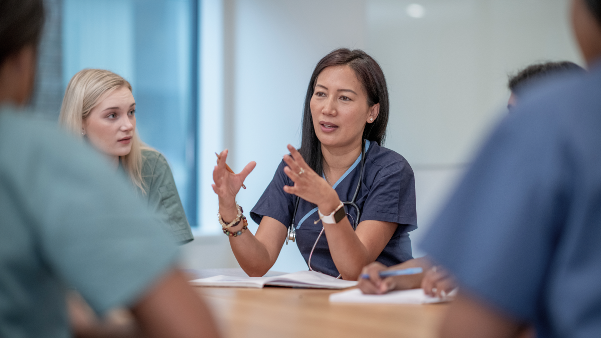 Doctor presents in a meeting to colleagues