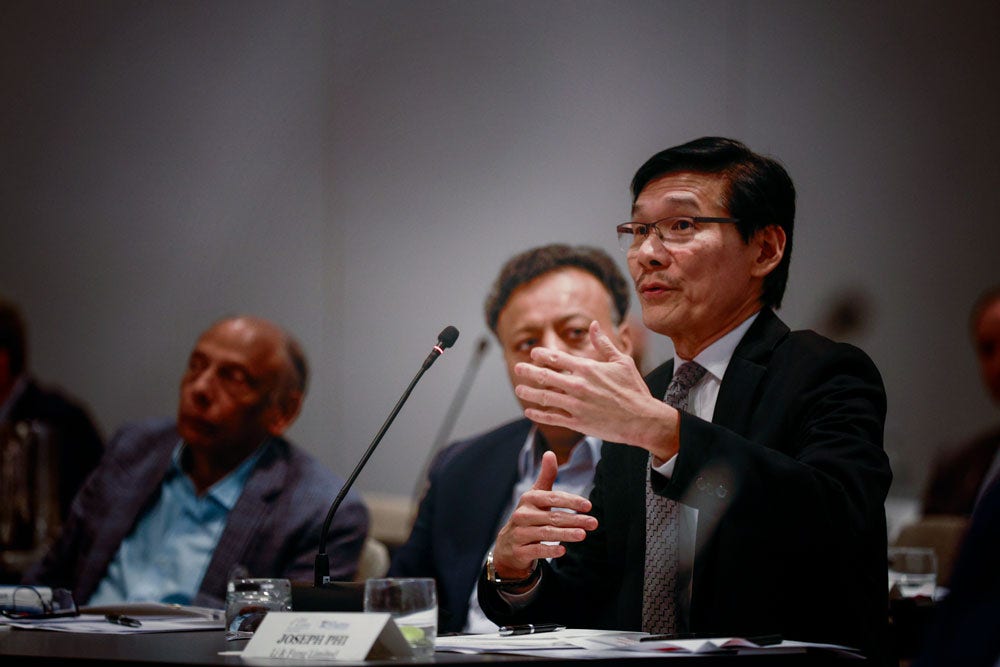 man speaking in front of a microphone