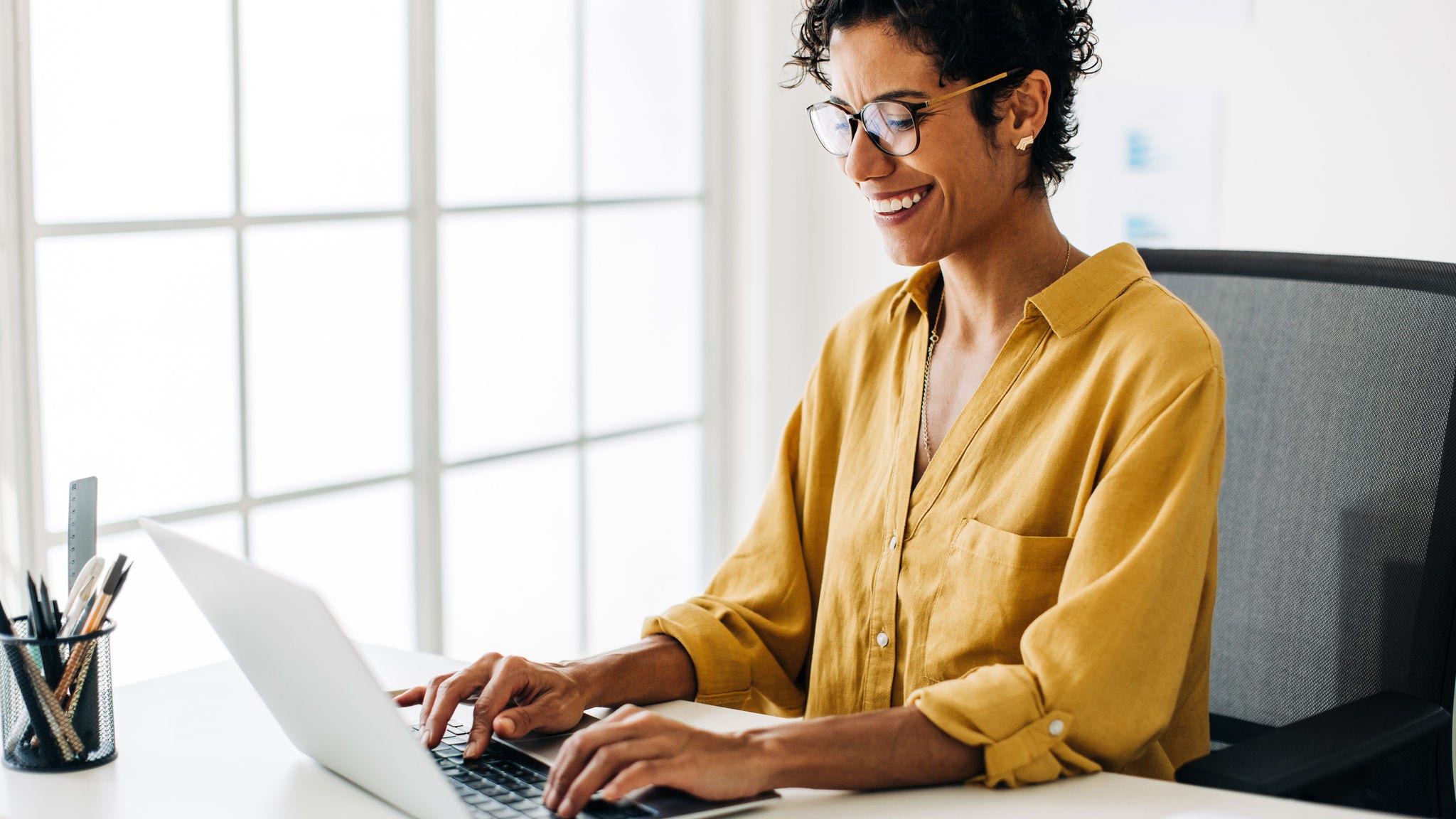 Woman does research on her laptop at home.