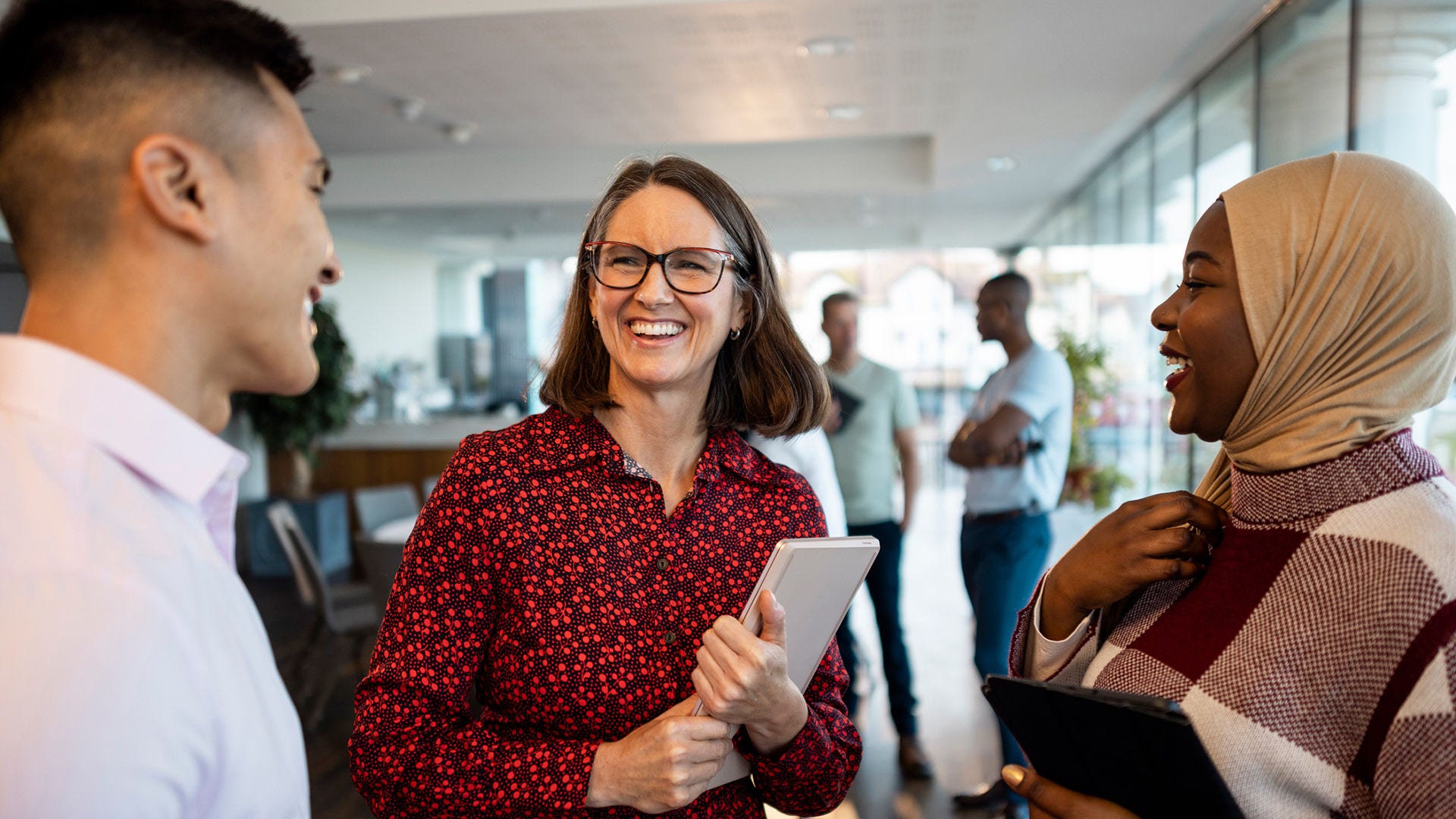 Manager laughs with her colleagues