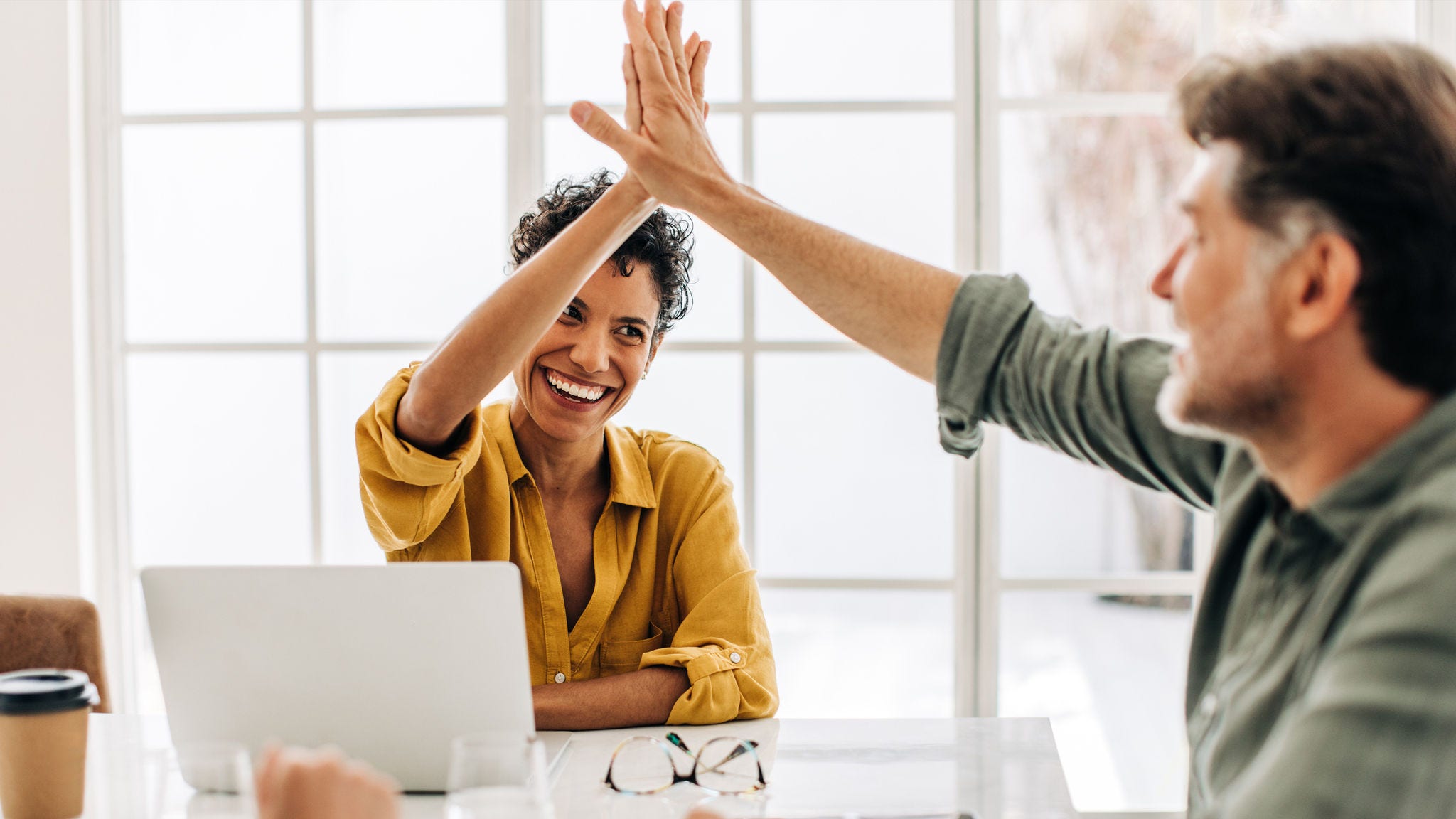 Woman and her colleague high five 