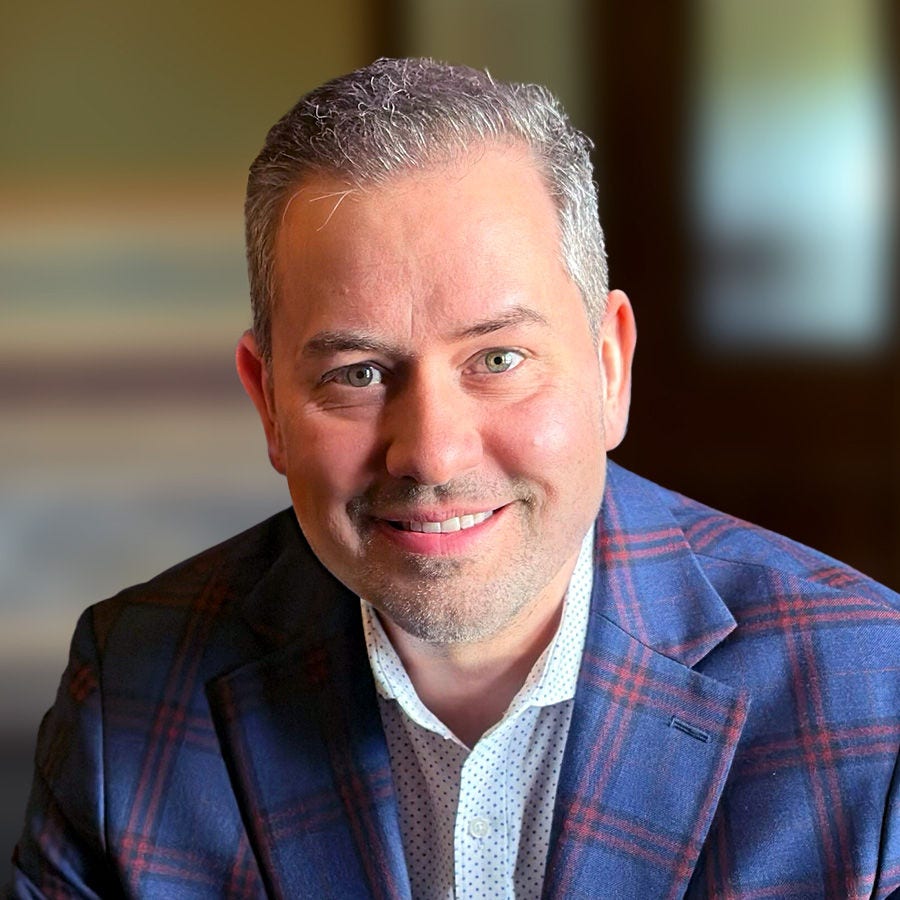 A headshot of Tomorrowist Host Justin Brady