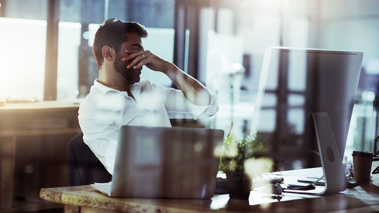 Man stressed sitting at desk