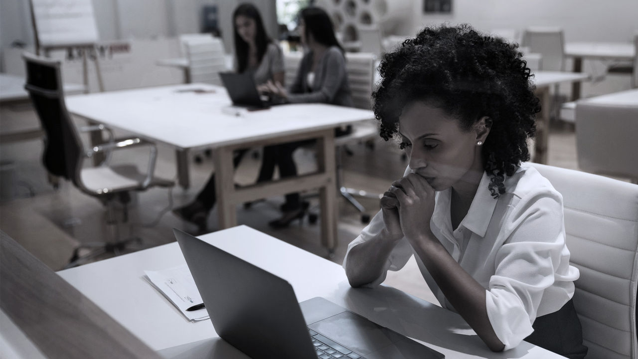 photo of employee looking concerned at a laptop