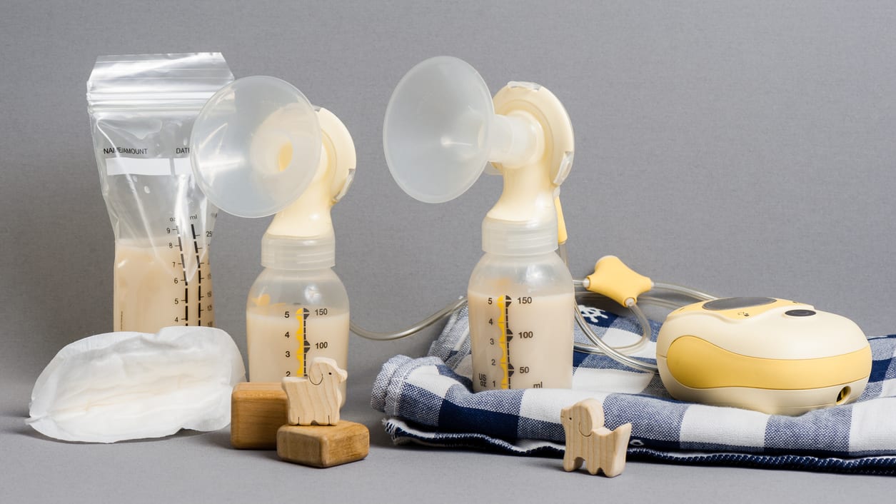 A set of breast pumps and other items on a gray background.