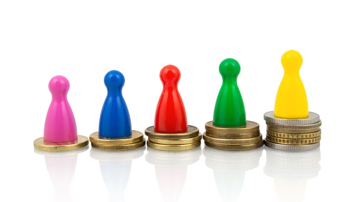 Colorful figures standing next to stacks of coins on a white background.