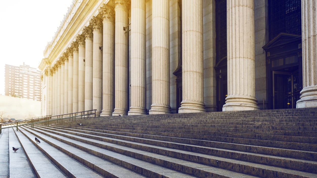 Steps leading up to a building with columns.