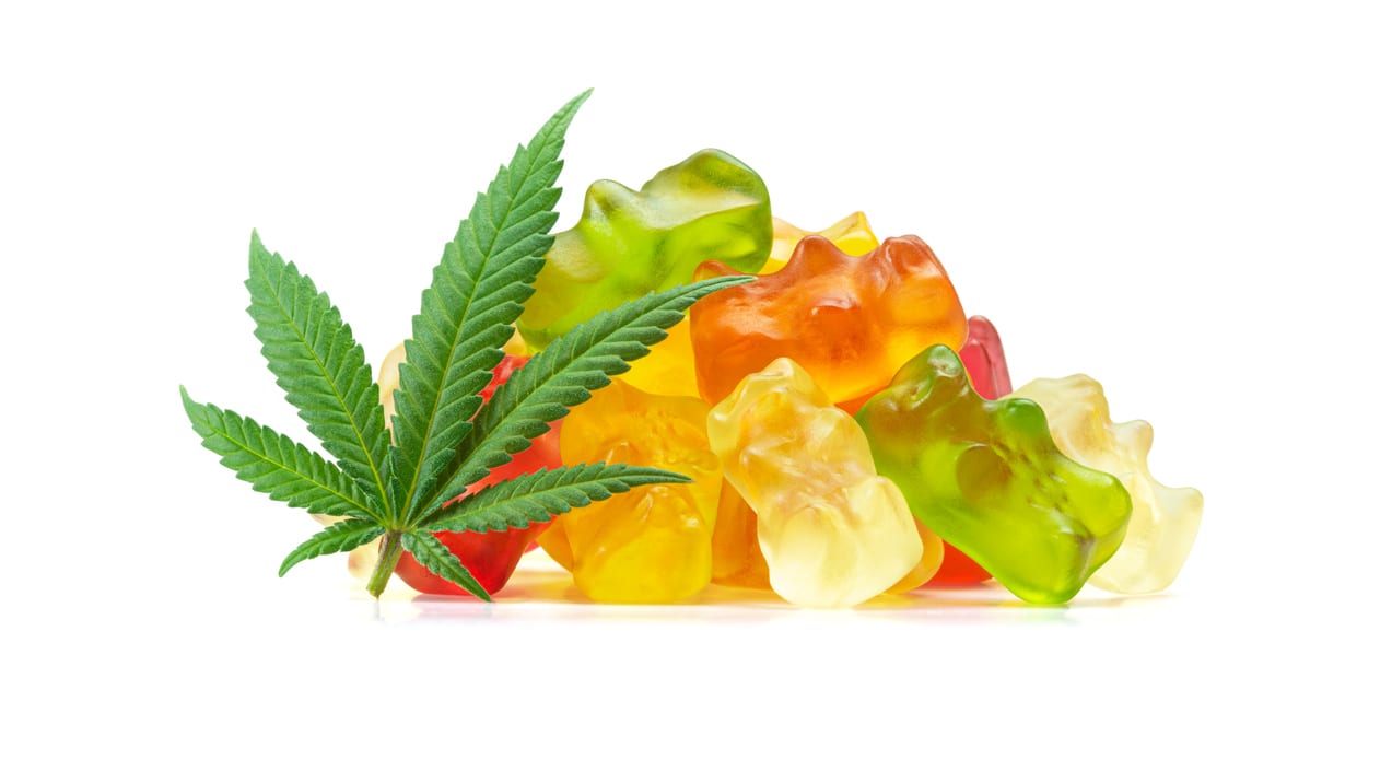 Cbd gummy bears and a marijuana leaf.