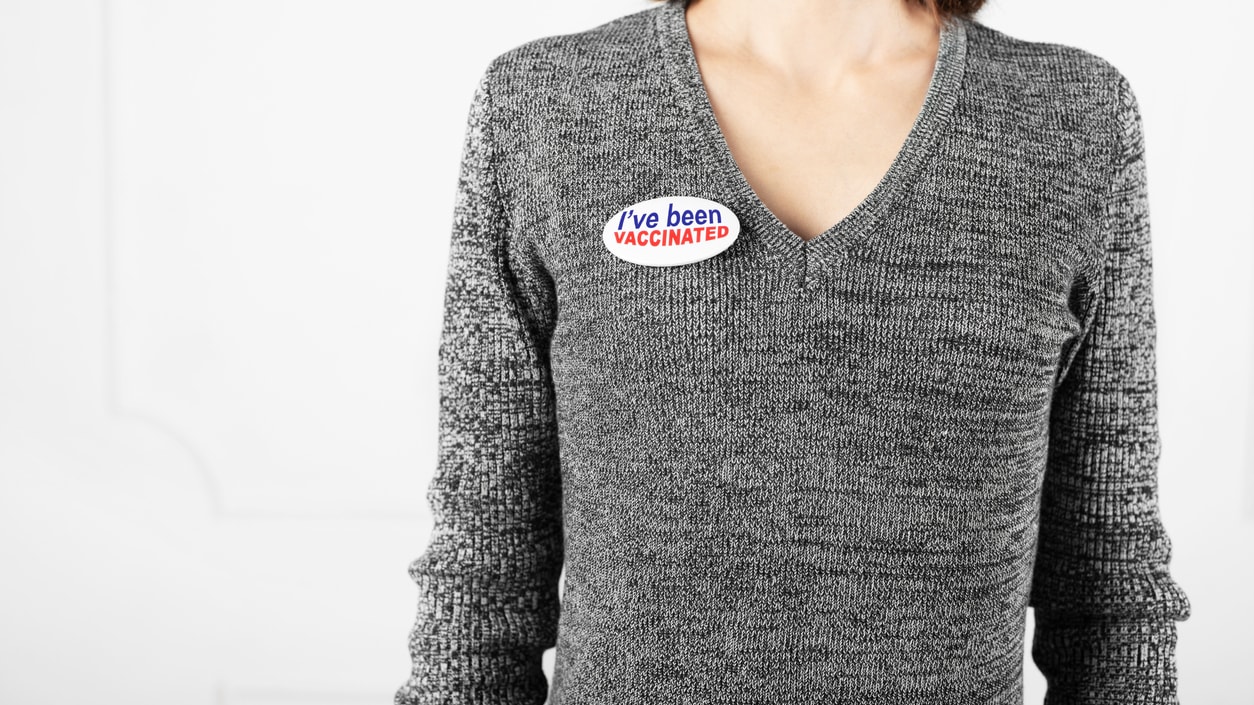 A woman with a voting sticker on her shirt.