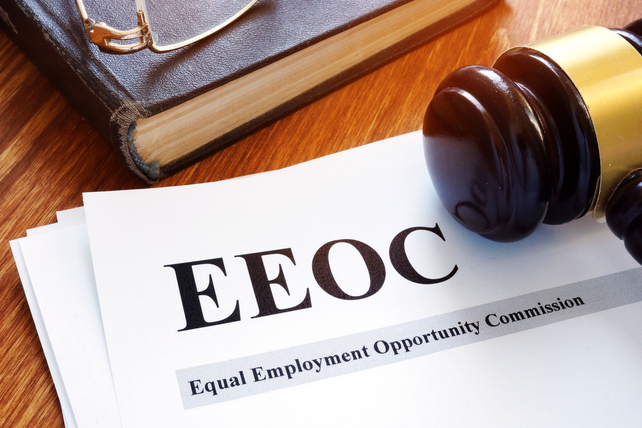 EEOC letterhead, a gavel, book and glasses