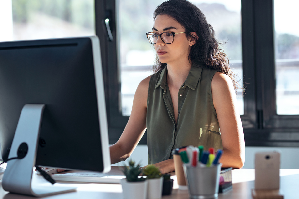 An HR professional working at her computer.