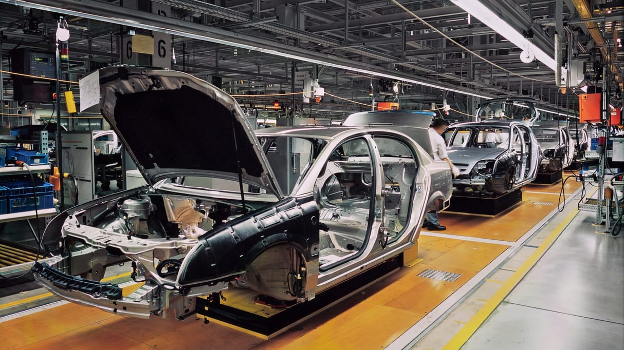 A car is being assembled in a factory.