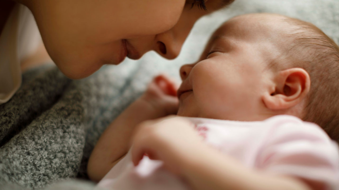 A mother with her face to her baby.