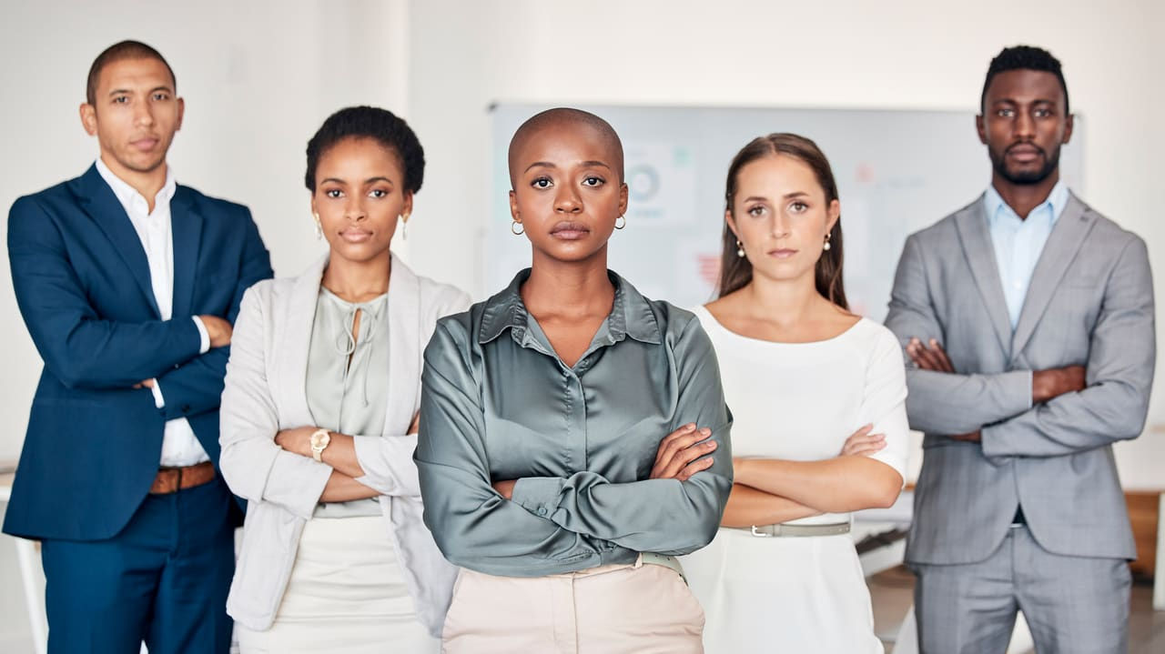 A group of business people standing together in an office.