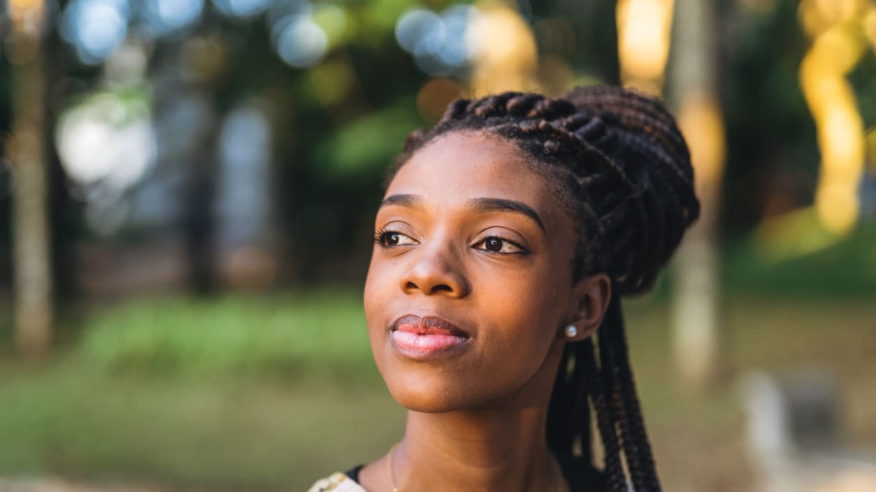 A young woman looking up at the sky.