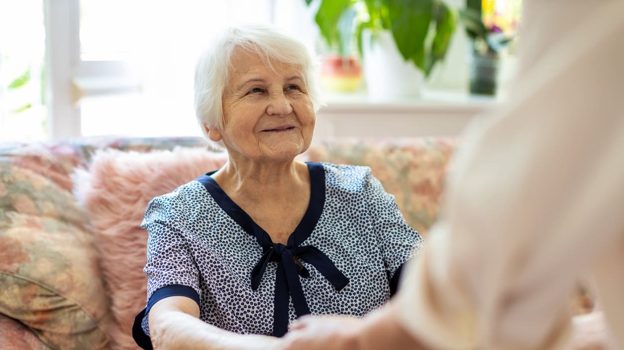 Someone helping an elderly woman.