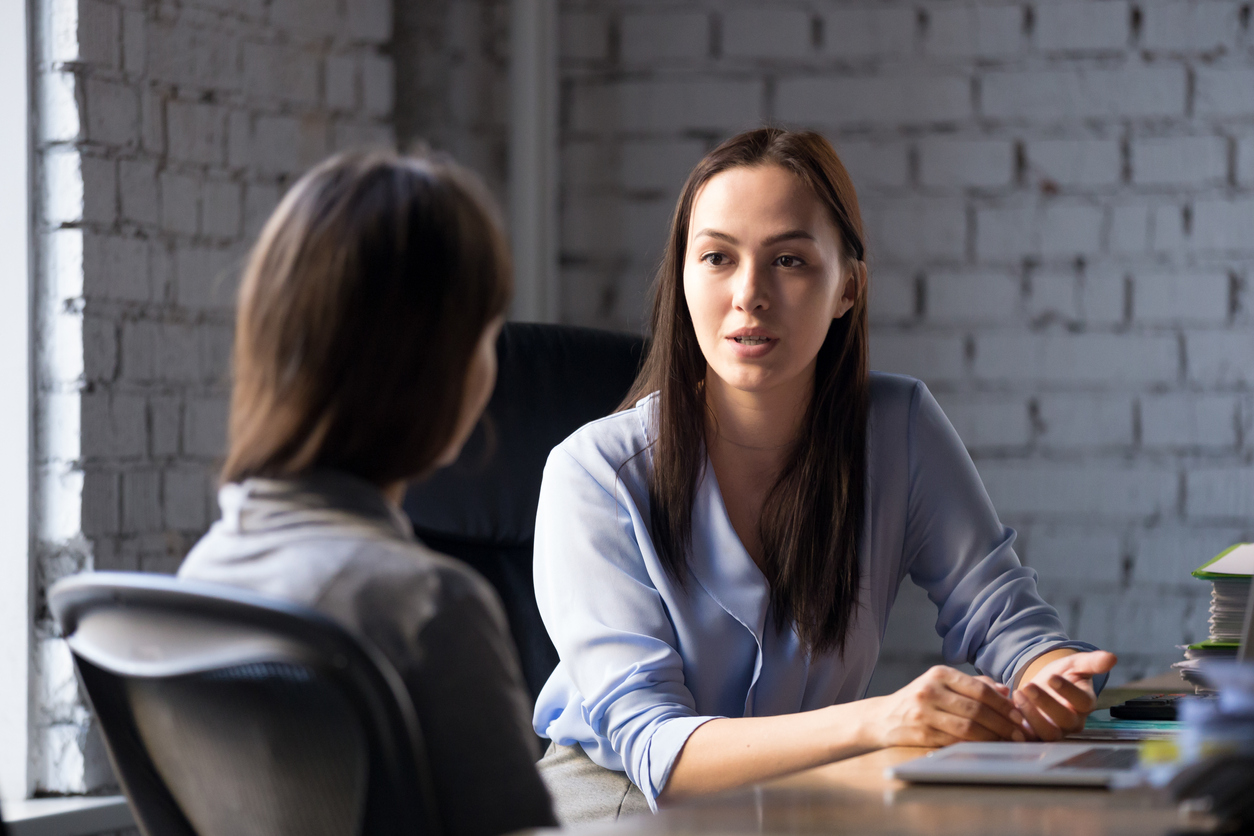 HR professional talking with an employee.