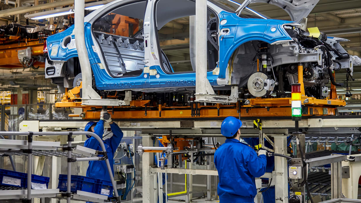 A blue car on the assembly line.