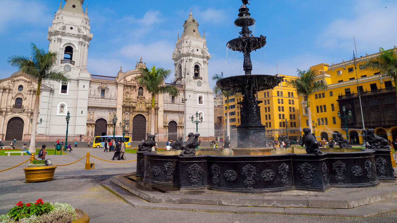 A fountain in front of a large building.