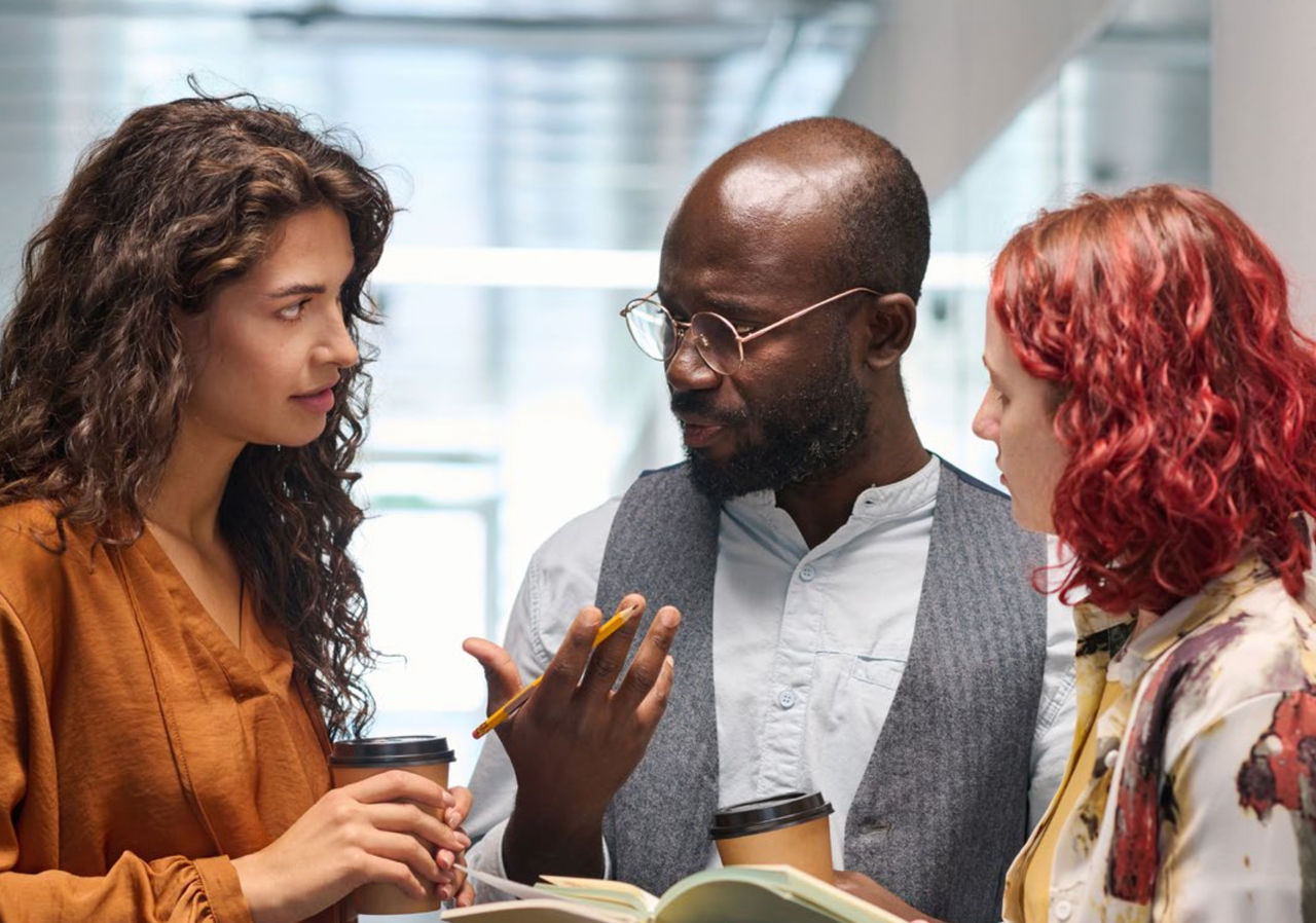 Three professionals in a discussion.