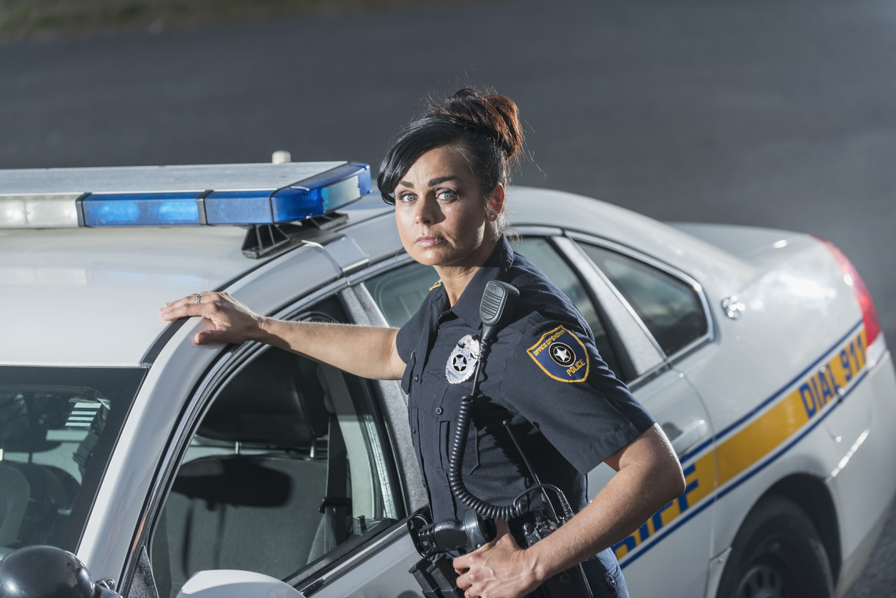 female police officer with car