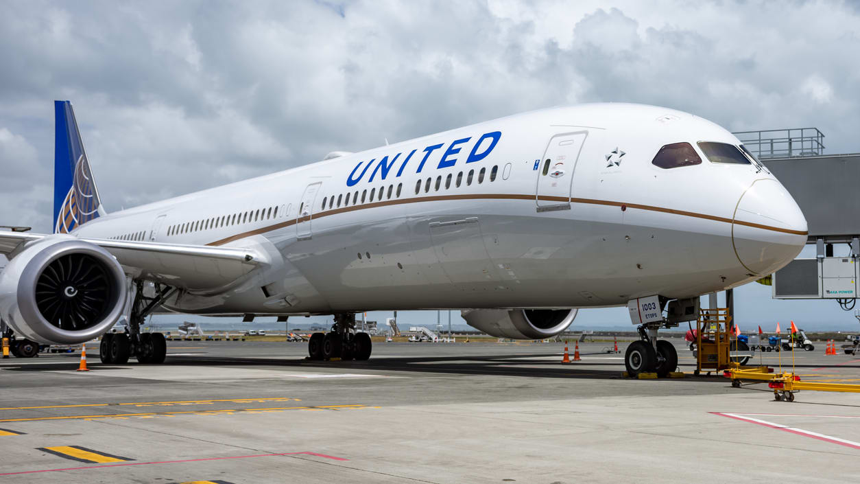 A united airlines airplane is parked on the tarmac.