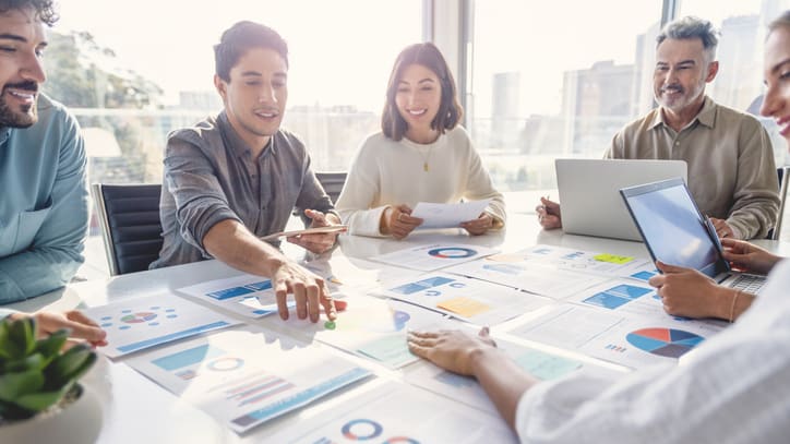 A group of business people sitting around a table.